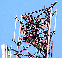 Four contractual power employees who climbed a mobile tower during a protest in Dehradun on Saturday