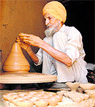 a potter makes earthen lamps for the festival in Dharamsala
