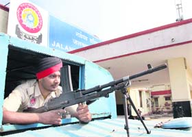 Another policeman performs his duty at a mobile police post outside the station in Jalandhar on Saturday