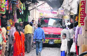 A fire brigade vehicle passed through a congested lane of Attari Bazaar during a fire mock drill on Saturday