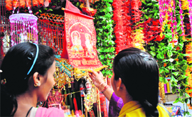 Residents purchase decorative material on Diwali eve at a market in Jammu on Saturday.