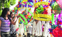 Girls look at paper lamps and gadvaras displayed at a market in Ludhiana on Saturday