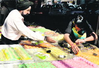 A man buys sweets in Ludhiana on Saturday. photo: Inderjeet Verma