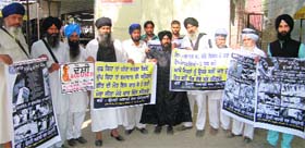 Religious leaders holding banners seeking justice for victims of anti-Sikh riots, in Bathinda on Monday