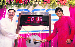 Bollywood actors Suresh Oberoi and Vivek Oberoi ring the bell during the 