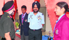 Maj Gen PS Mander, ADG, NCC, felicitates cadet Neha in Chandigarh. A Tribune photograph