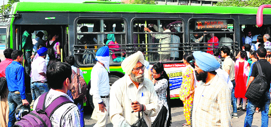 An overloaded bus at the Sector 17 ISBT. Shortage of buses is forcing commuters 