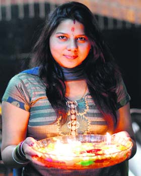 A woman prepares for Diwali pujan in Dehradun on Sunday