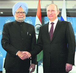 Prime Minister Manmohan Singh shakes hands with Russian President Vladimir Putin at the BRICS 5 Summit in Durban, South Africa
