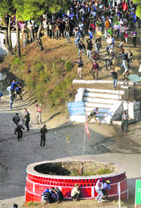 People participate in the traditional Pathar Mela at Dhami village, 25 km from Shimla, on Monday.
