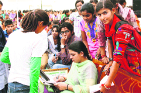 Kanta Duhan, who scaled the Mount Everest, gives autographs to girls at a function in Fatehabad.