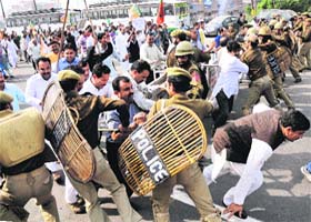 BJP leaders and activists scuffle with the police during a protest against the coalition government in Jammu on Monday