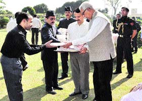 Governor NN Vohra distributes sweets to staff members of the Governors secretatriat in Raj Bhawan in Jammu on Sunday