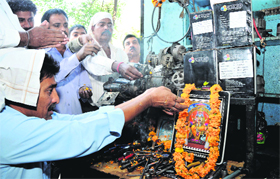 Workers pay obeisance to Lord Vishwakarma on Vishwakarma Day in Jammu on Monday.