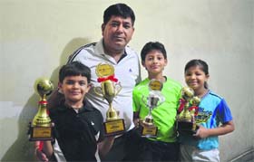 Lakshaya, Arnam and Sanya with their coach, Mangat Rai Sharma, in Ludhiana