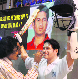 An artist gives finishing touches to Tendulkars wax statue