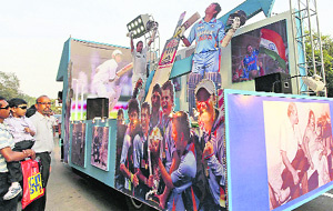 People watch a Tendulkar Tableau being taken across the city.
