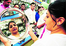 A woman purchases utensils in Amritsar on Diwali