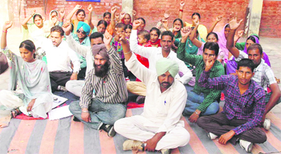 Members of the Sakhar Prerak Union staging a dharna outside the office of Zila Parishad in Bathinda on Tuesday.