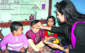 A woman applies tilak to her brother on the occassion of Bhaiya Dooj in Dehradun on Tuesday.