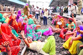 Protesting residents of Lalupura and adjoining villages block rail traffic on the Delhi-Ambala line against land consolidation at Karnal railway station on Tuesday