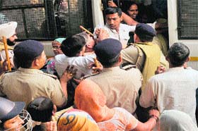 Policemen round up protesters