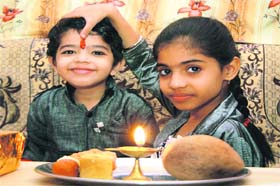 A girl applies tilak on her brothers forehead on the occasion of Bhaiya Dooj in Gurgaon on Tuesday