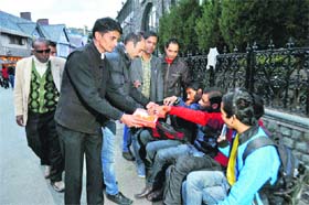 Sunil Thakur, BJYM state president, and supporters distribute sweets, following the Himachal Pradesh High Court decision to restore the Dharamsala cricket stadium to the HPCA, in Shimla on Tuesday