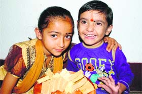 A little girl and her brother celebrate Bhaiya Dooj in Mandi on Tuesday