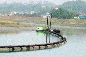 A dredger being used in the Balancing reservoir in Sundernagar