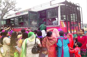 A mad rush of women for a private bus