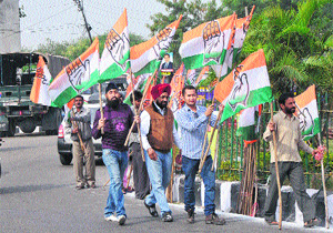 Congress workers carry party flags to be installed at roadsides in Jammu, where All India Congress Committee vice-president Rahul Gandhi will address a panchayat conference on Wednesday.
