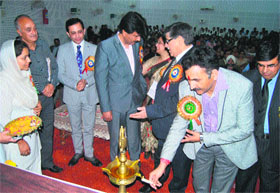 Minister of State for Fisheries Manohar Lal Sharma lights the lamp during the inaugural function of the J&K Womens Science Congress in Jammu on Tuesday