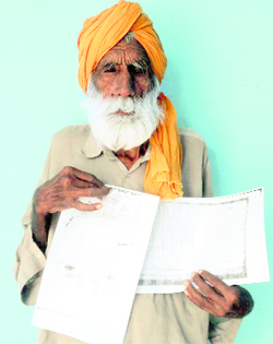 Harnam Singh showing the revenue records.