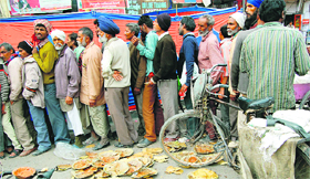 People queue up outside a stall serving langar in Amritsar.