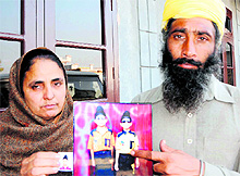 The parents of 10-year-old Gurkirat Singh, who was found murdered, show his photograph at their residence in Verka
