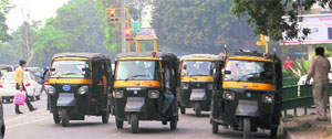 Auto-rickshaws move covering almost the entire one side of a road in Phase VI, Mohali