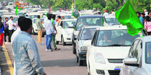 Vehicles of INLD workers and supporters move at a snails pace near Majri Chowk in Panchkula on Wednesday.