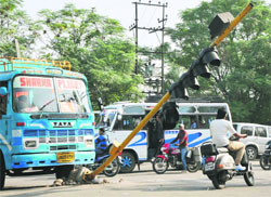 A damaged traffic light pole at the Roop Nagar Chowk poses risk to commuters in Jammu.