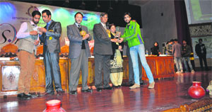 A winner receives his prize from KU Vice-Chancellor Prof Talat Ahmed in Srinagar on Wednesday. 