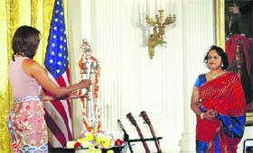 US First Lady Michelle Obama lights a lamp during Diwali celebrations at the White House in Washington
