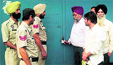 A team of the House Tax Department of the Municipal Corporation seals a factory on the Batala road in Amritsar on Thursday