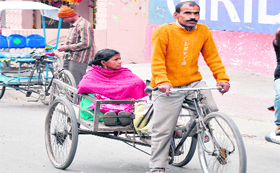 A couple on a rickshaw on a cloudy morning in Haridwar on Thursday.