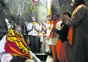 Devotees offer prayers inside the Shiv Khori cave shrine