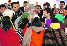 Congress vice-president Rahul Gandhi and J&K Chief Minister Omar Abdullah interact with members of women self-help groups in Central Kashmirs Budgam district, on Thursday