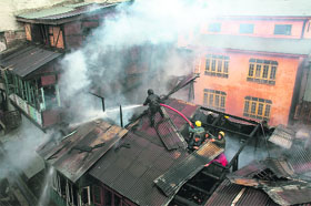 Firefighters try to douse flames at the Maharaja Bazar locality in Srinagar on Thursday