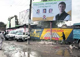 A man walks near a puddle outside the Congress Headquarters in Srinagar on Thursday
