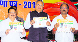 Chhattishgarh CM Raman Singh (C), along with party leader JP Nadda (L) and Education Minister Brijmohan Agarwal, releases BJP manifesto in Raipur, Chhattisgarh.