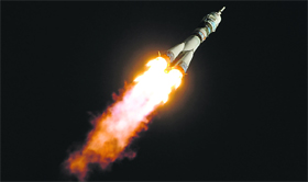 Russias Soyuz TMA-11M spacecraft carrying an unlit Olympic torch for the 2014 Winter Games in Sochi aboard flies after blasting off from Kazakhstan.