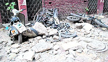 The vehicles which were damaged due to the collapse of a portion of projection of the third floor of a building at Dharam Singh Market, near Jallianwala Bagh, in Amritsar on Friday
